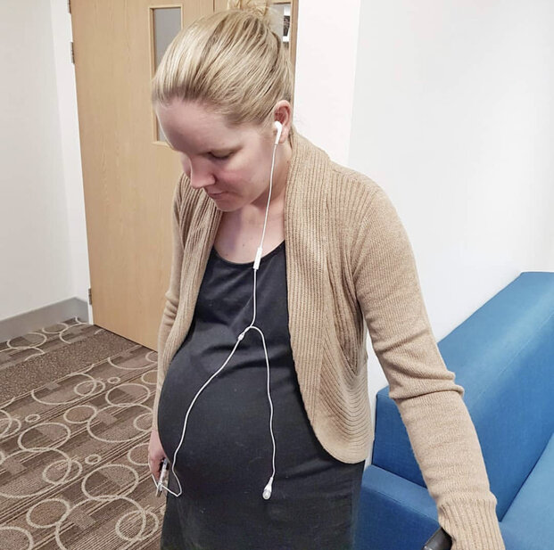 Pregnant mum listening to hypnobirthing tracks in labour at hospital