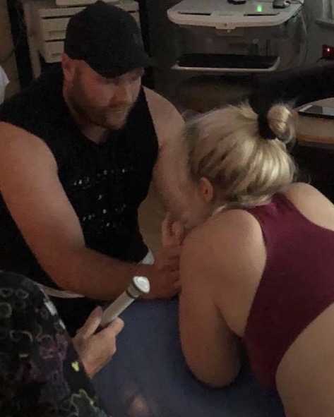 Pregnant mum labouring at birth centre with partner helping 