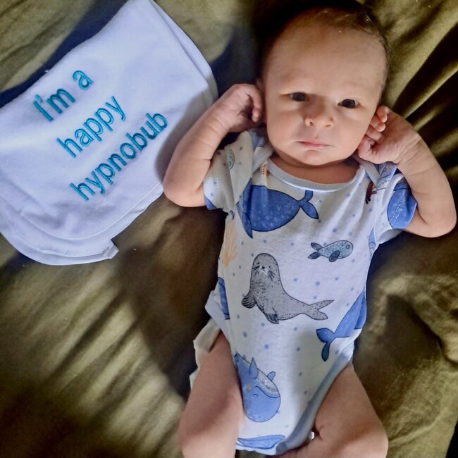 Baby with bid next him saying Happy Hypnobub