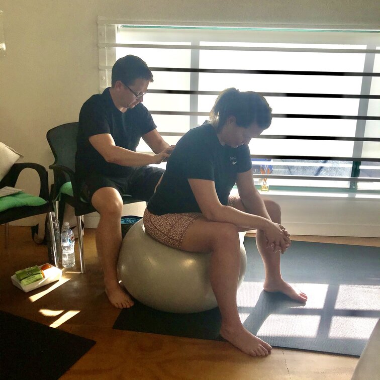 Pregnant couple doing hypnobirthing techniques in class