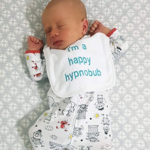 Baby wearing bid that says Happy Hypnobub
