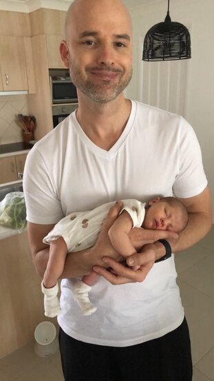 Dad holding baby in his arms