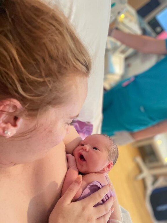 Mum holding newborn baby after birth