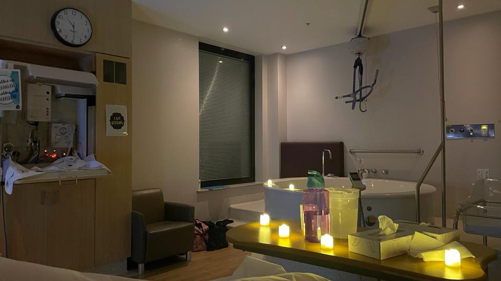 Hospital birth suite set up with dim lighting, led lights