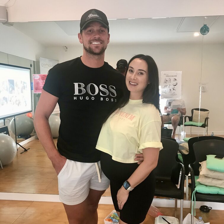 Couple sitting on a couch. Hypnobirthing Australia Course Privately