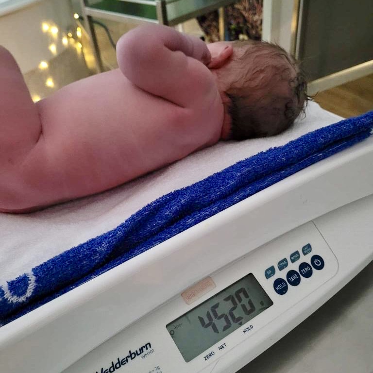 Baby lying on scales weighing 4520g