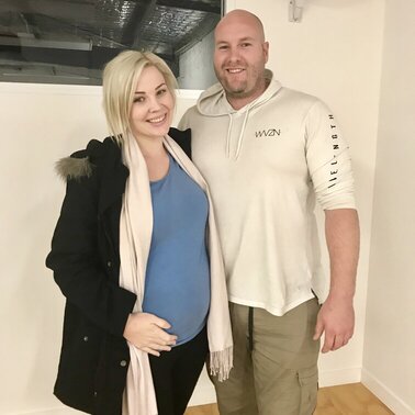 Couple sitting on a couch. Hypnobirthing Australia Course Privately