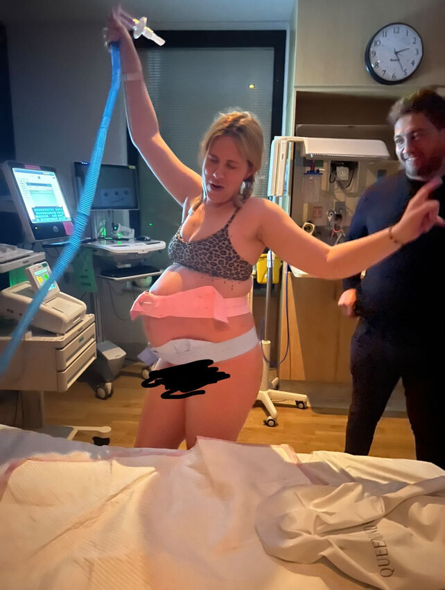 Pregnant mum laughing and using gas in hospital room