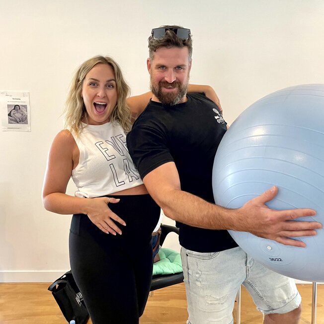 Couple sitting on a couch. Hypnobirthing Australia Course Privately