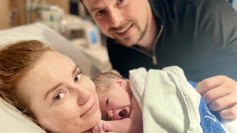 Positively Hypnobirthing mum and dad holding newborn baby