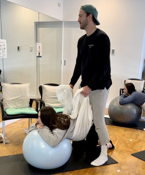 Pregnant couple working on hypnobirthing techniques in hypnobirthing class on the gold coast