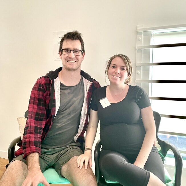 Couple sitting on a couch. Hypnobirthing Australia Course Privately