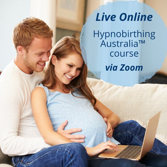 Pregnant couple sitting on couch learning hypnobirthing techniques live online