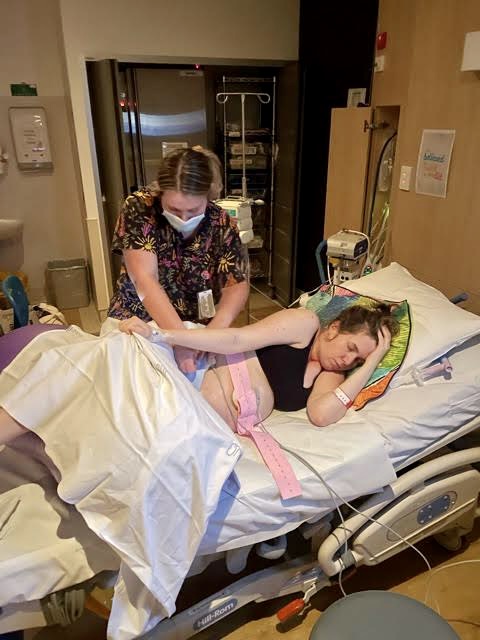 Mum in hopspital bed on side at Gold Coast Hospital in labour