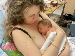 Emily holding her baby boy Villa