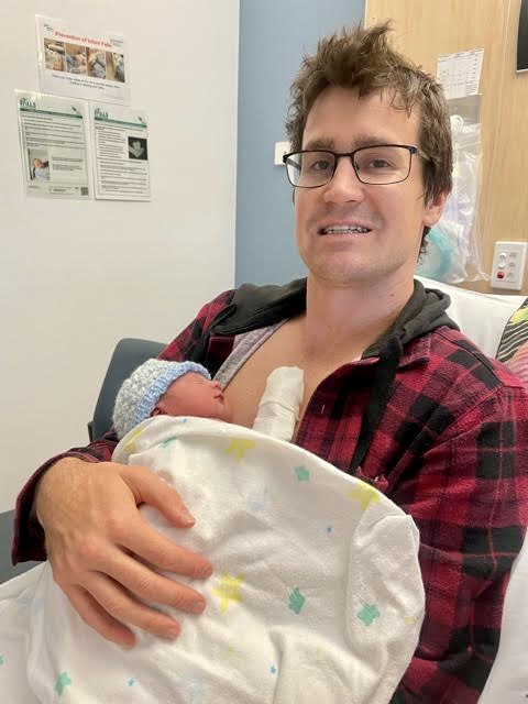 Dad holding newborn baby boy