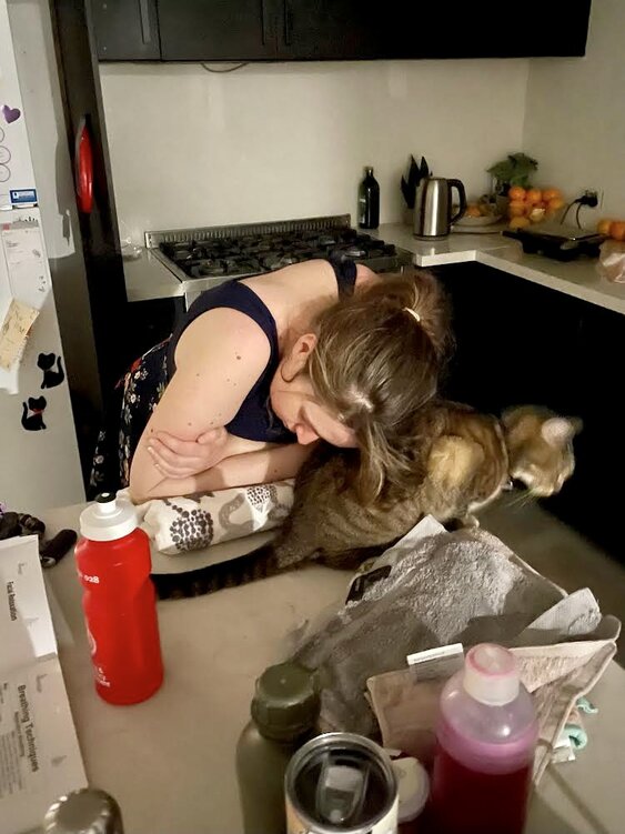 Mum leaning on kitchen bench in labour using hypnobirthing techniques
