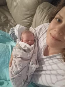 Mum holding newborn baby at home