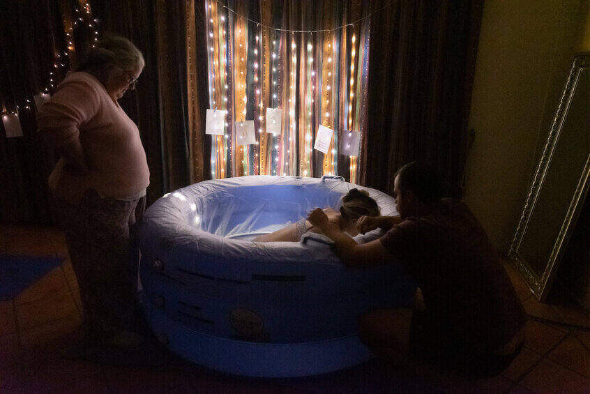 mum labouring in birth pool. Home birth