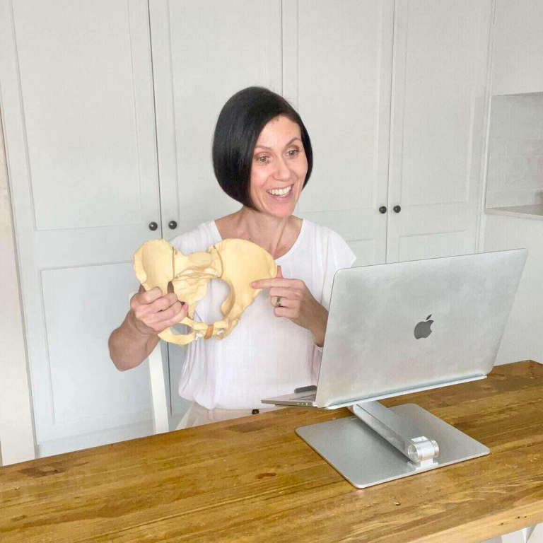 Holding birth prop and teaching online hypnobirthing childbirth education