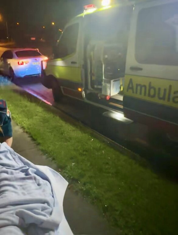 Ambulance waiting at night to take a Gold Coast mum and her newborn to hospital after an unplanned car birth