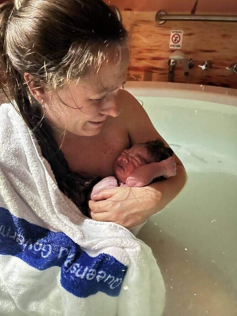 Mum holding newborn baby in hospital